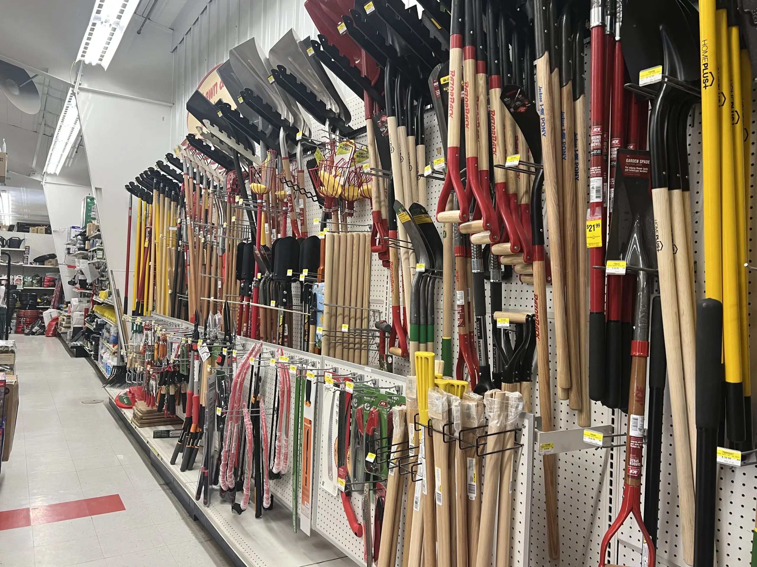 Hardware store aisle with rakes and shovels